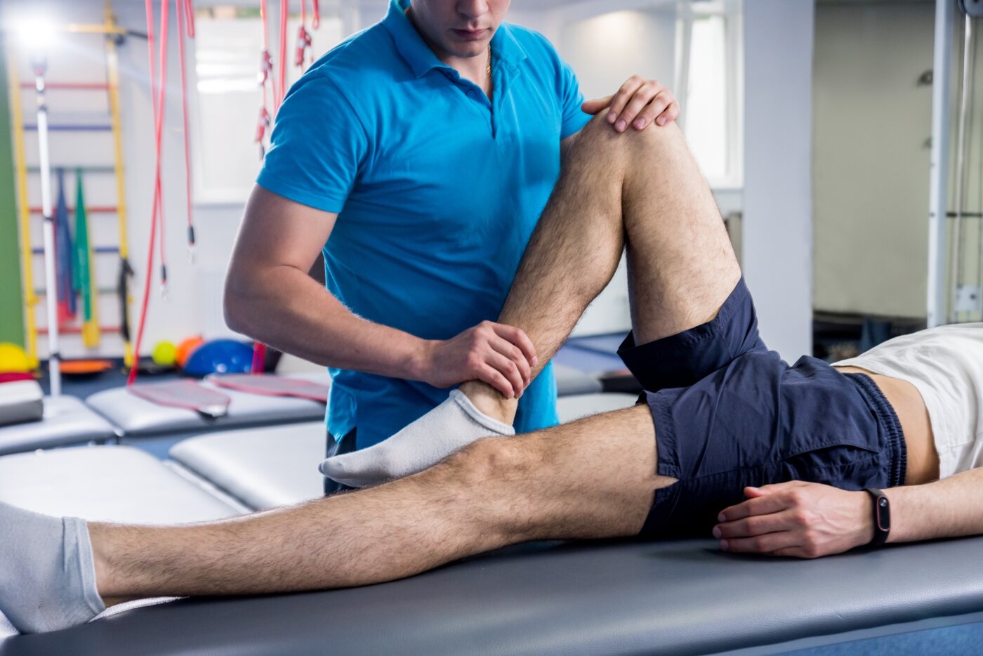 Physical therapist treating a patient’s knee